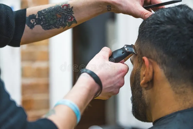 Skilled barber using clippers for a modern skin fade haircut